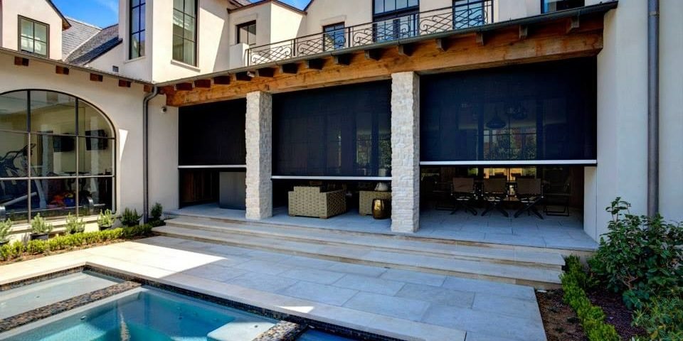 Expert team installing motorized patio screen on San Antonio covered deck